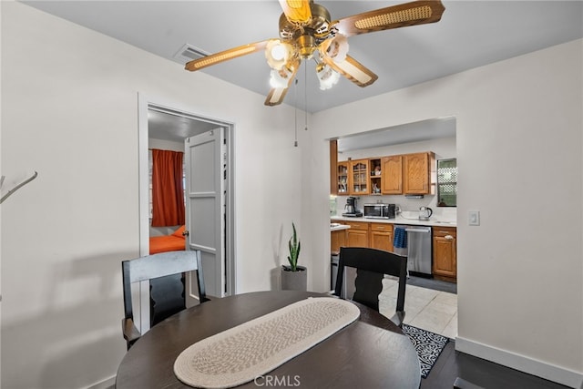 tiled dining space with ceiling fan