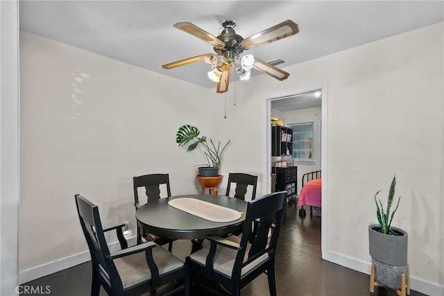 dining space featuring ceiling fan and dark hardwood / wood-style flooring