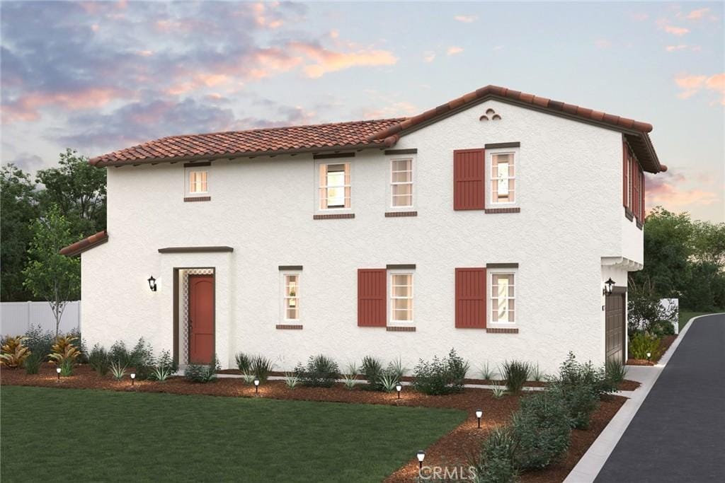 mediterranean / spanish house with a yard