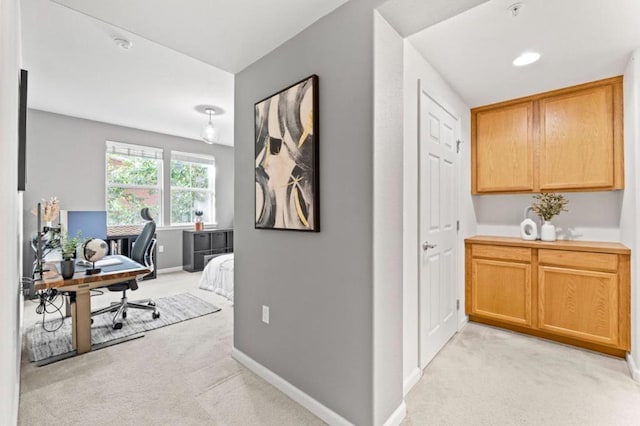 hall featuring light colored carpet