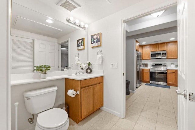 bathroom with tile patterned floors, vanity, and toilet