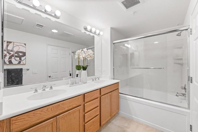 bathroom featuring combined bath / shower with glass door and vanity