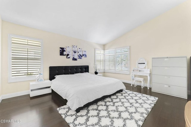 bedroom with dark hardwood / wood-style flooring and lofted ceiling