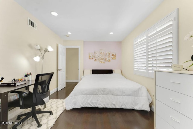 bedroom with dark hardwood / wood-style flooring