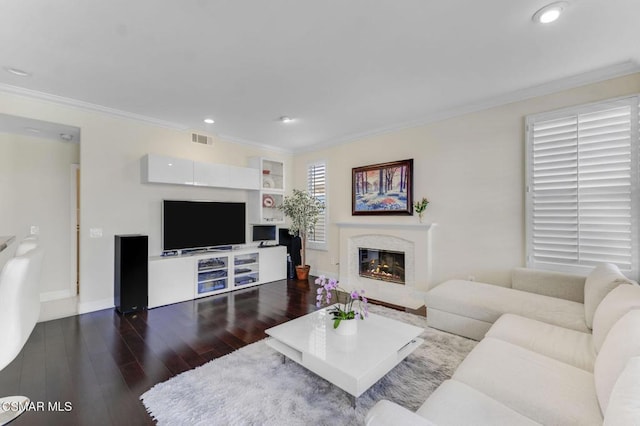 living room featuring dark hardwood / wood-style flooring and crown molding