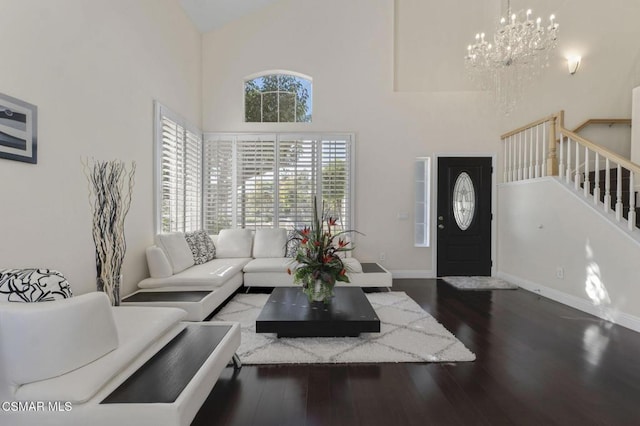 living room with hardwood / wood-style floors and high vaulted ceiling