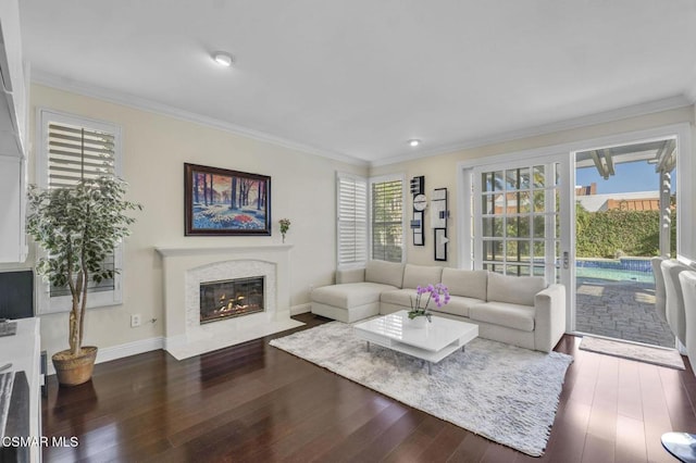 living room with dark hardwood / wood-style flooring, crown molding, and a healthy amount of sunlight