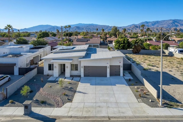 view of front facade featuring a mountain view and a garage