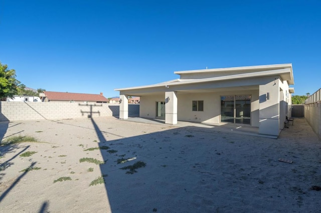 back of property with central AC unit and a patio area