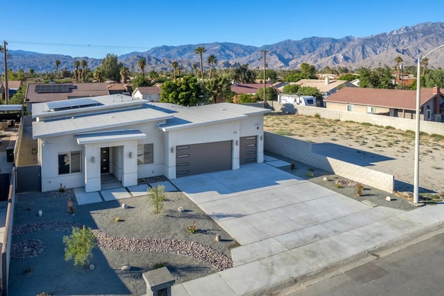 view of front facade featuring a mountain view and a garage