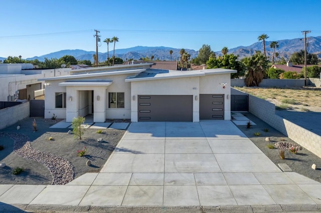 view of front of property with a garage and a mountain view