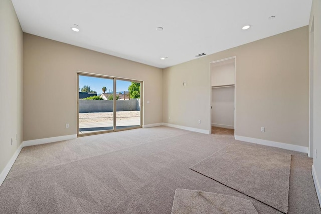 spare room featuring light colored carpet