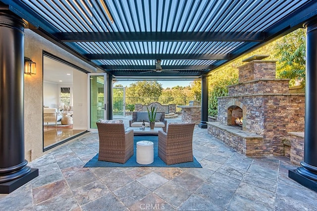 view of patio / terrace featuring an outdoor living space with a fireplace and a pergola