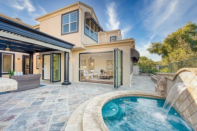 back of property featuring a fenced in pool, a patio area, fence, and stucco siding