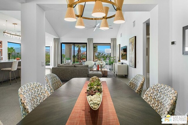 dining space with high vaulted ceiling and an inviting chandelier