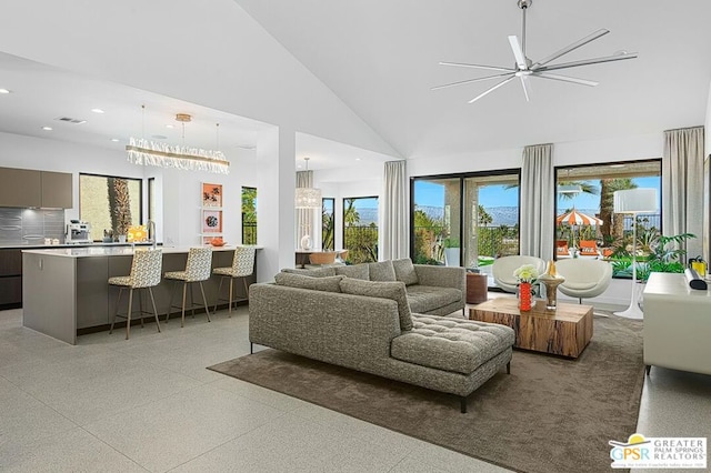 living room featuring high vaulted ceiling and ceiling fan