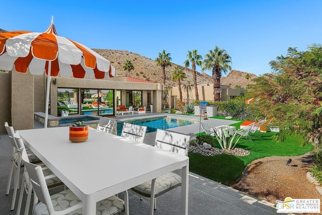 view of swimming pool featuring a patio area and a mountain view