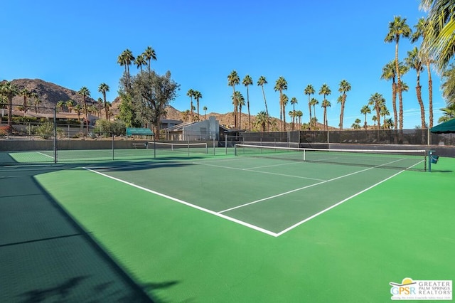 view of tennis court with a mountain view