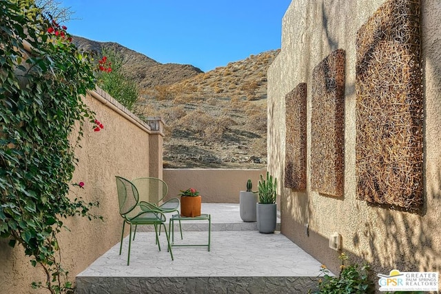 view of patio / terrace featuring a mountain view