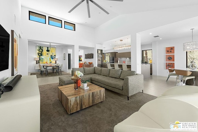 living room featuring ceiling fan and a high ceiling