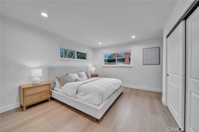 bedroom featuring a closet and light hardwood / wood-style flooring