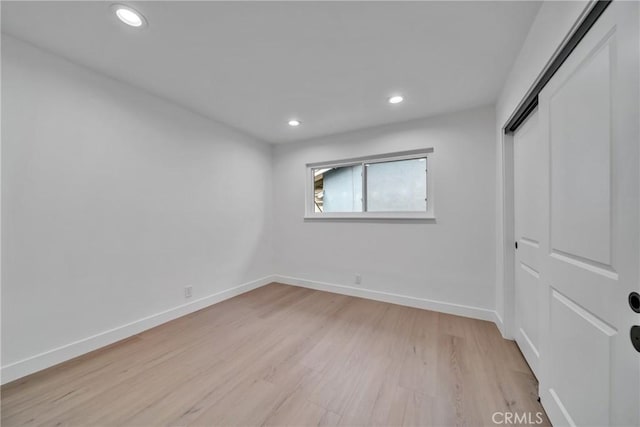 unfurnished room with light wood-type flooring