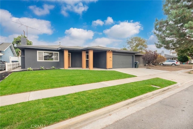 view of front facade with a garage and a front lawn