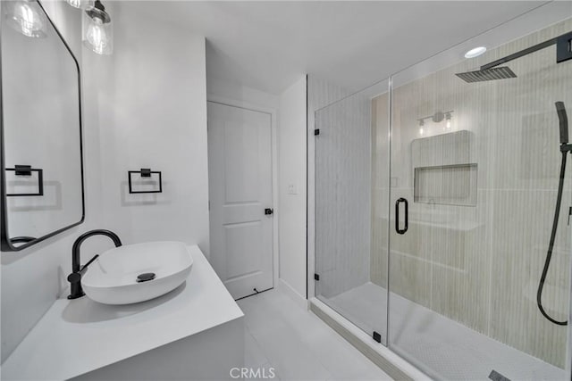 bathroom with vanity, tile patterned flooring, and a shower with door