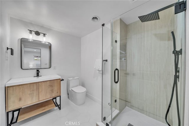 bathroom with toilet, tile patterned floors, vanity, and a shower with shower door