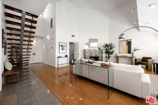 living room with hardwood / wood-style flooring and a high ceiling