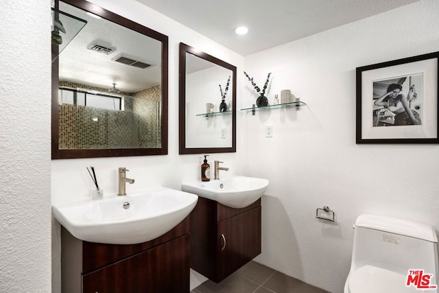 bathroom featuring toilet, tile patterned flooring, and vanity