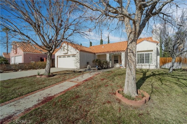 mediterranean / spanish house with a front yard and a garage