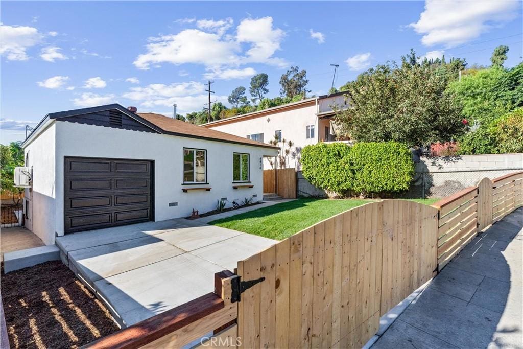 view of front of property with a front lawn and a garage