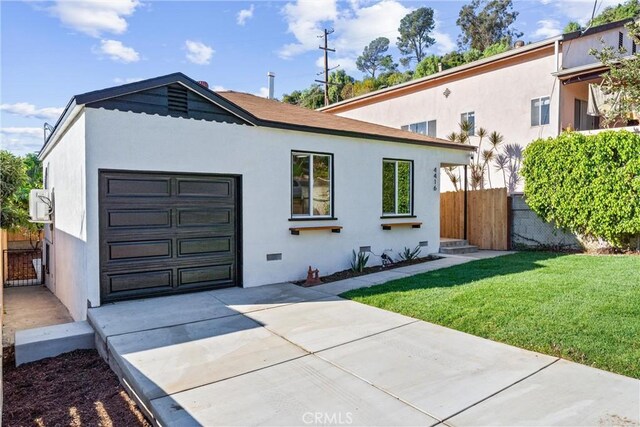 view of front of home with a garage and a front lawn