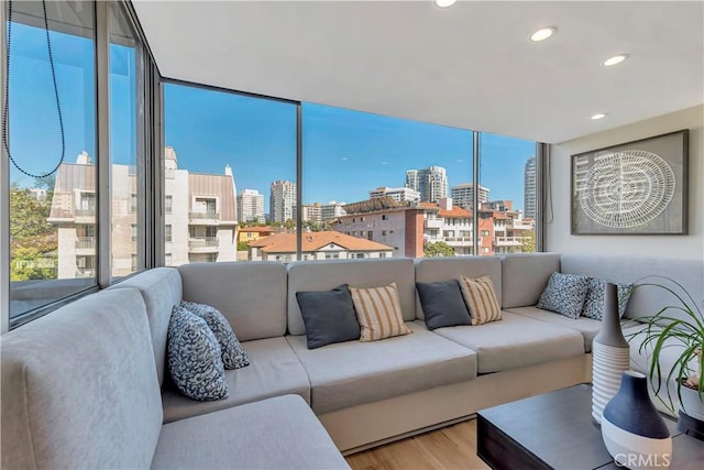 living room featuring hardwood / wood-style floors, expansive windows, and a wealth of natural light