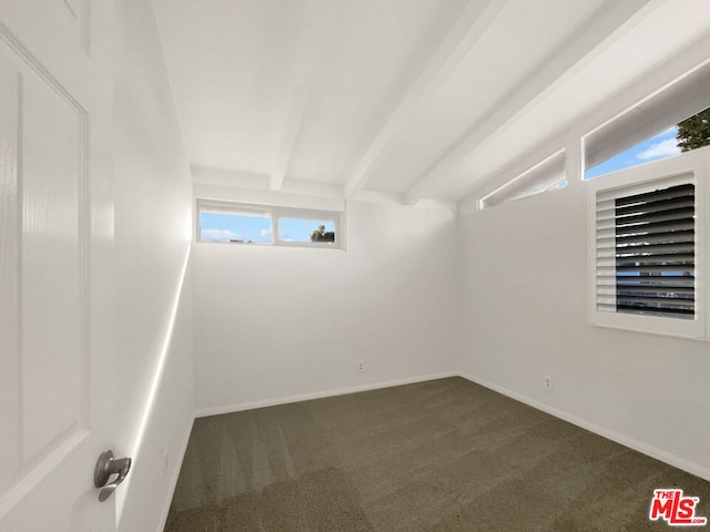 carpeted empty room with vaulted ceiling with beams