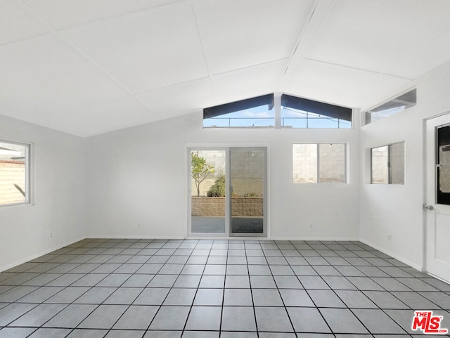 tiled empty room with lofted ceiling