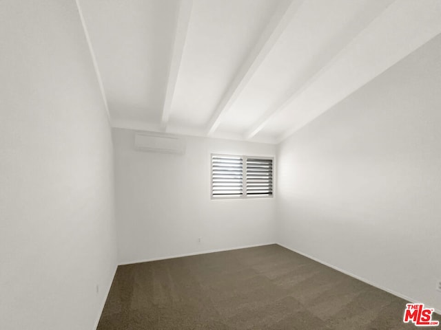 unfurnished room with an AC wall unit, dark colored carpet, and vaulted ceiling with beams