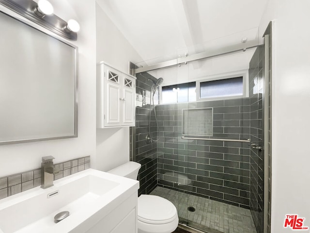 bathroom with toilet, vanity, and walk in shower