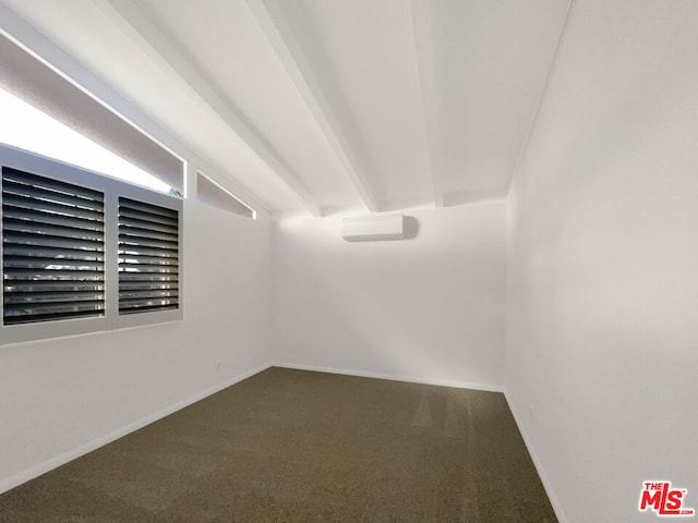 carpeted empty room with a wall mounted AC and vaulted ceiling with beams