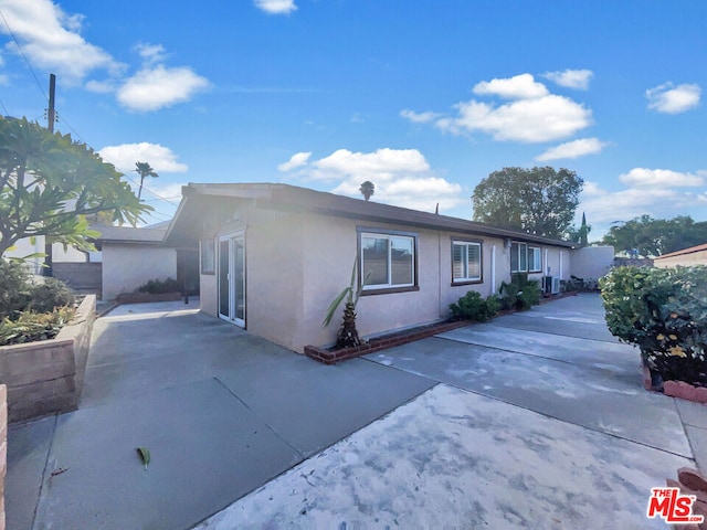 single story home featuring central AC and a patio area