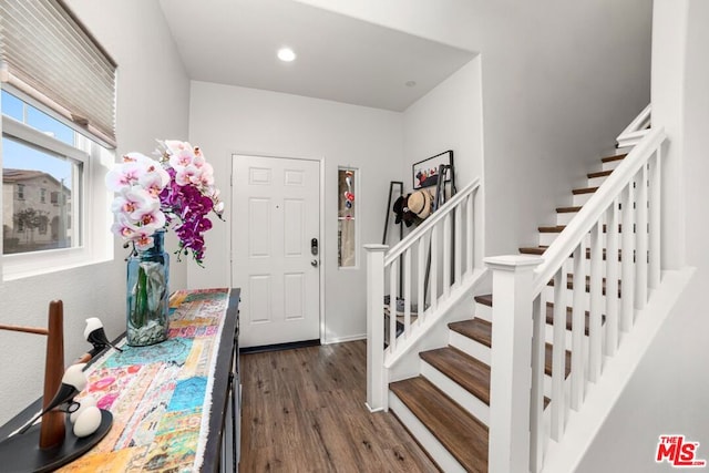 entryway with dark hardwood / wood-style flooring