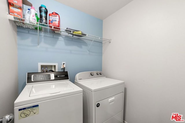 clothes washing area with separate washer and dryer