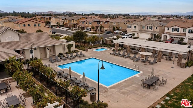 view of swimming pool with a patio area and a mountain view