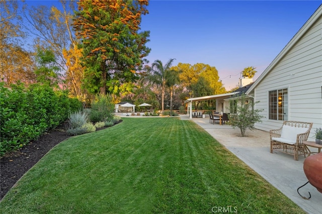 yard at dusk with a patio