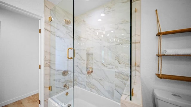 bathroom featuring toilet, enclosed tub / shower combo, and wood-type flooring