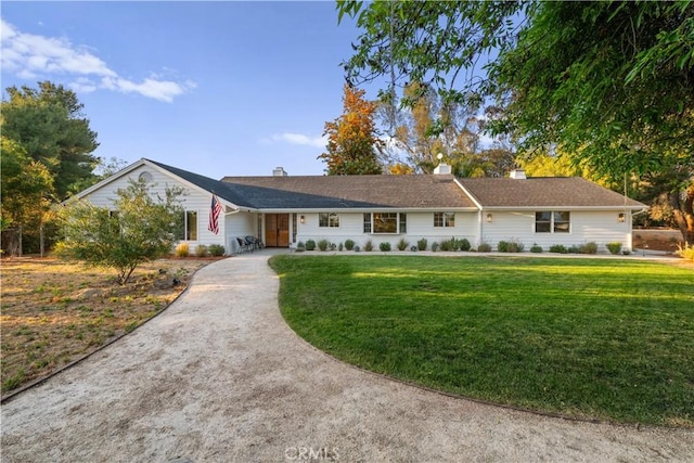 single story home with a front lawn