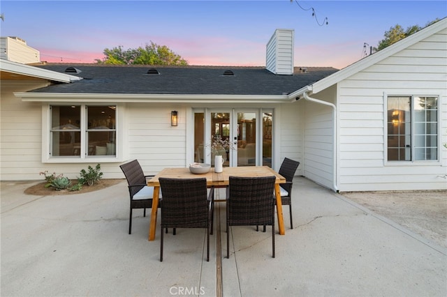 patio terrace at dusk featuring french doors