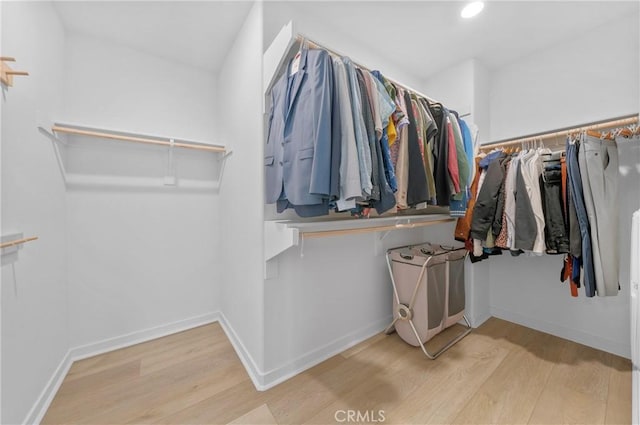 walk in closet with wood-type flooring