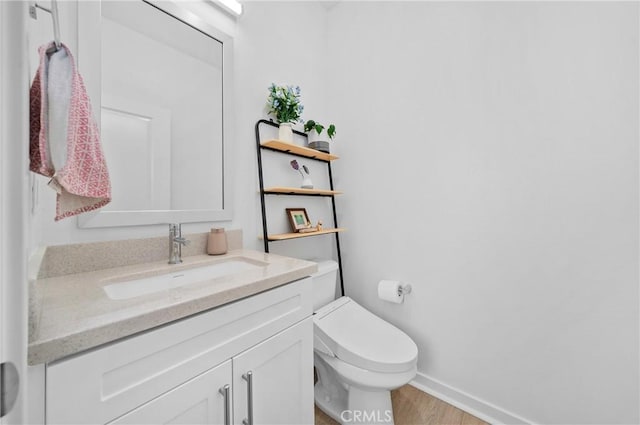 bathroom with vanity, hardwood / wood-style flooring, and toilet